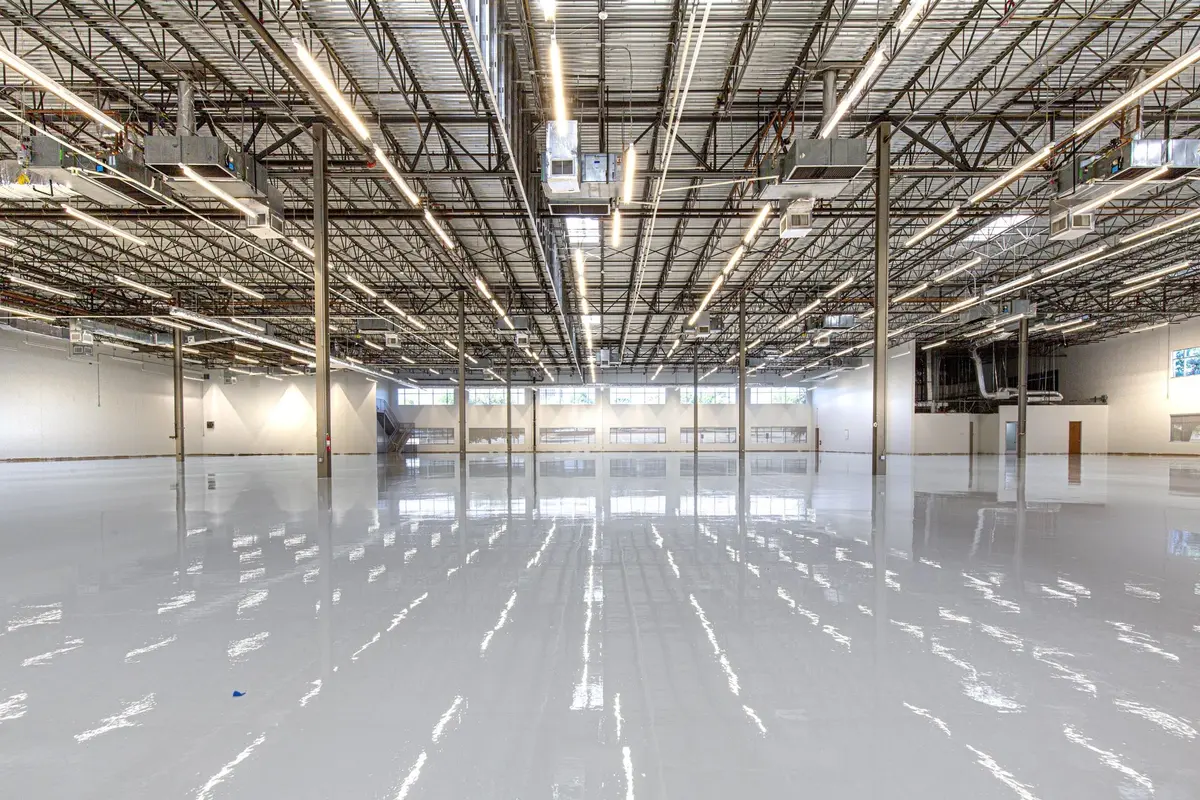 Glossy gray epoxy coating on a large warehouse floor